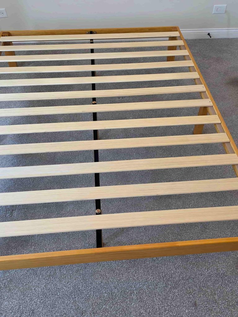 Wooden bed frame in a residential bedroom in Lakeview, Chicago.
