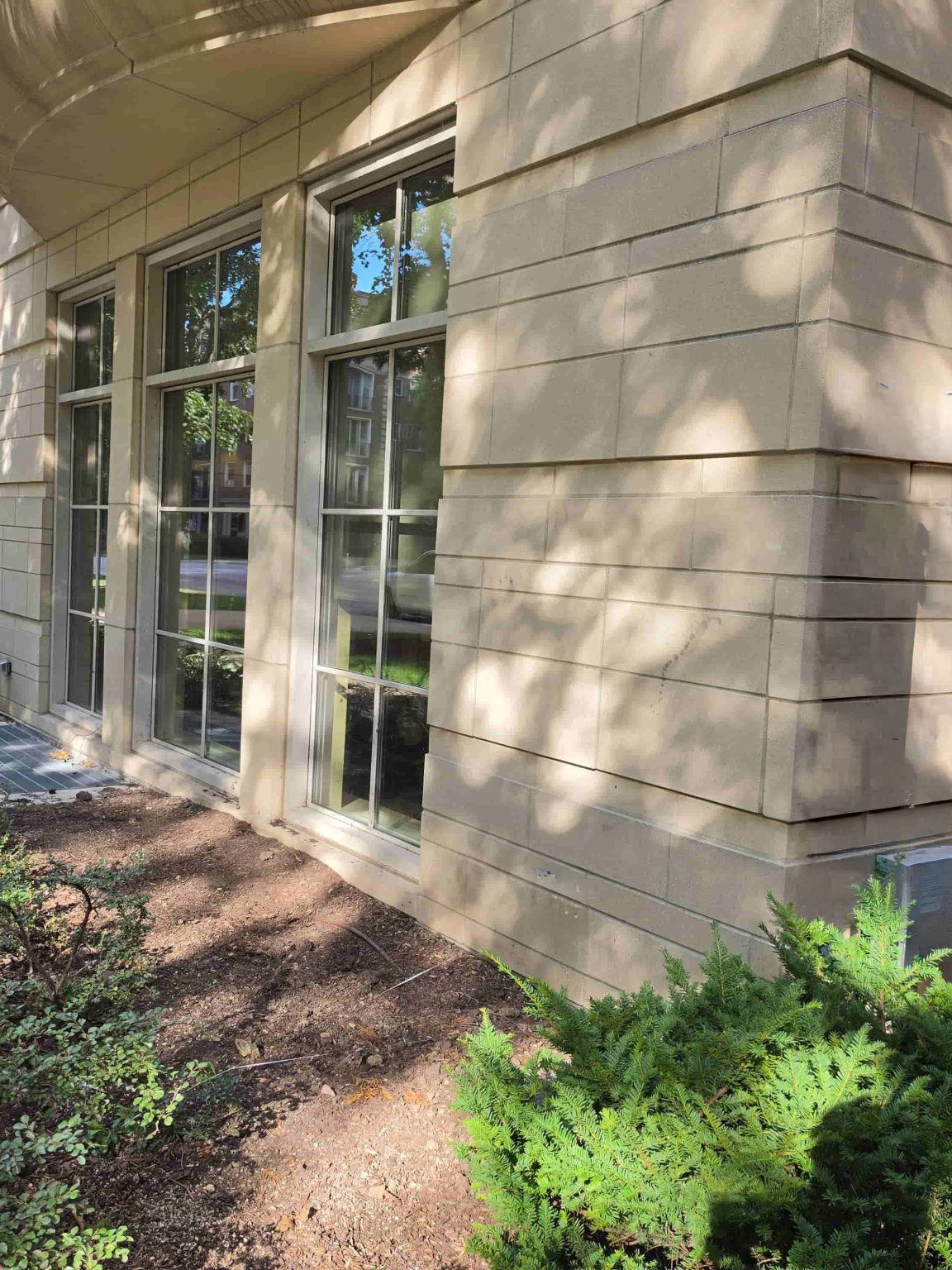Masonry residential building in Evanston with tall windows and landscaped exterior grounds.
