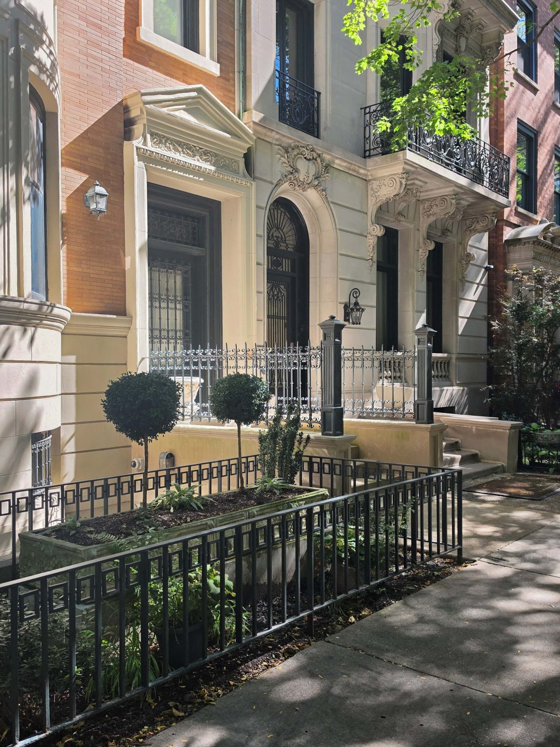 Ornate stone entrances and iron railings along Gold Coast residential façades.