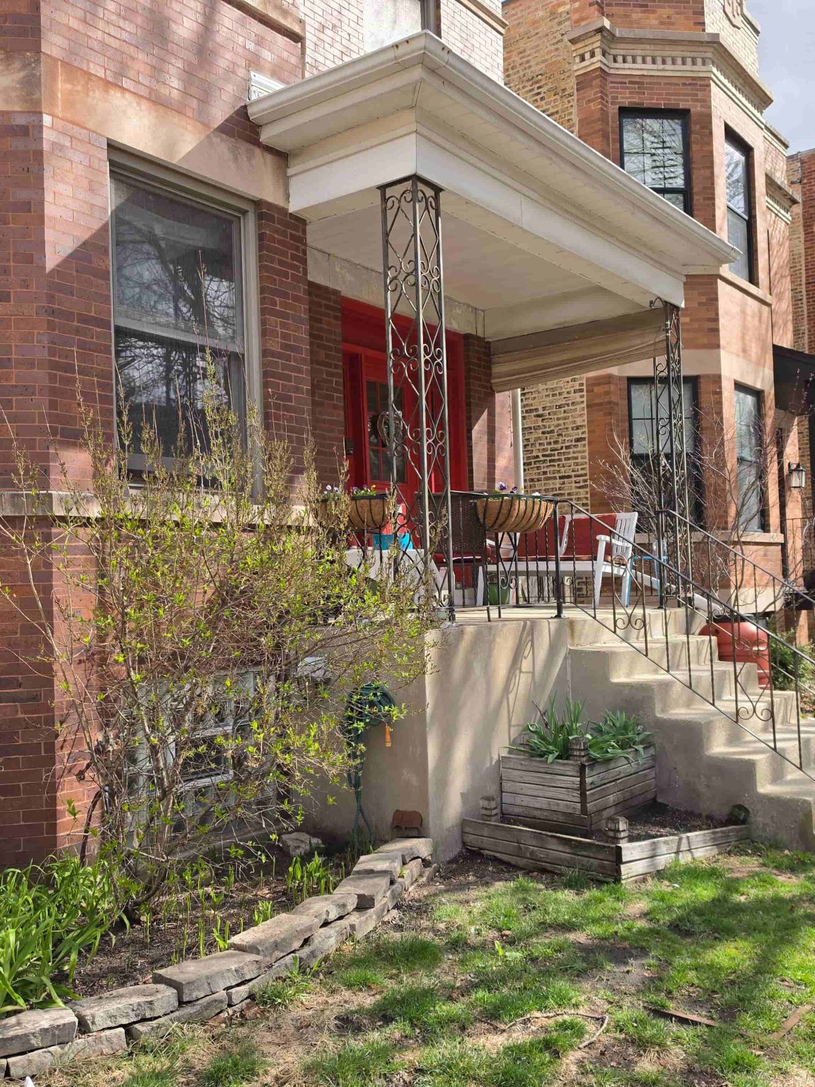 Brick residential building in Lincoln Square, Chicago, with a covered front entry, masonry detailing, landscaping, and neighboring homes.
