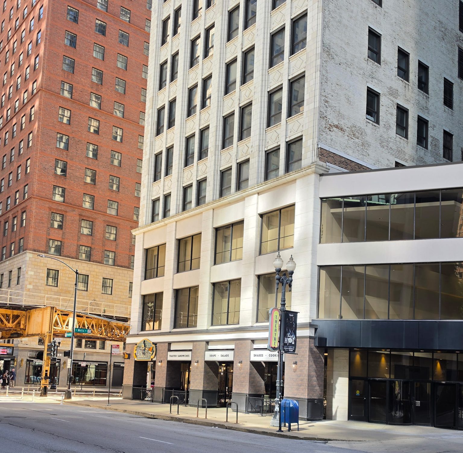 Brick and stone buildings beside elevated train tracks in Chicago’s Loop.