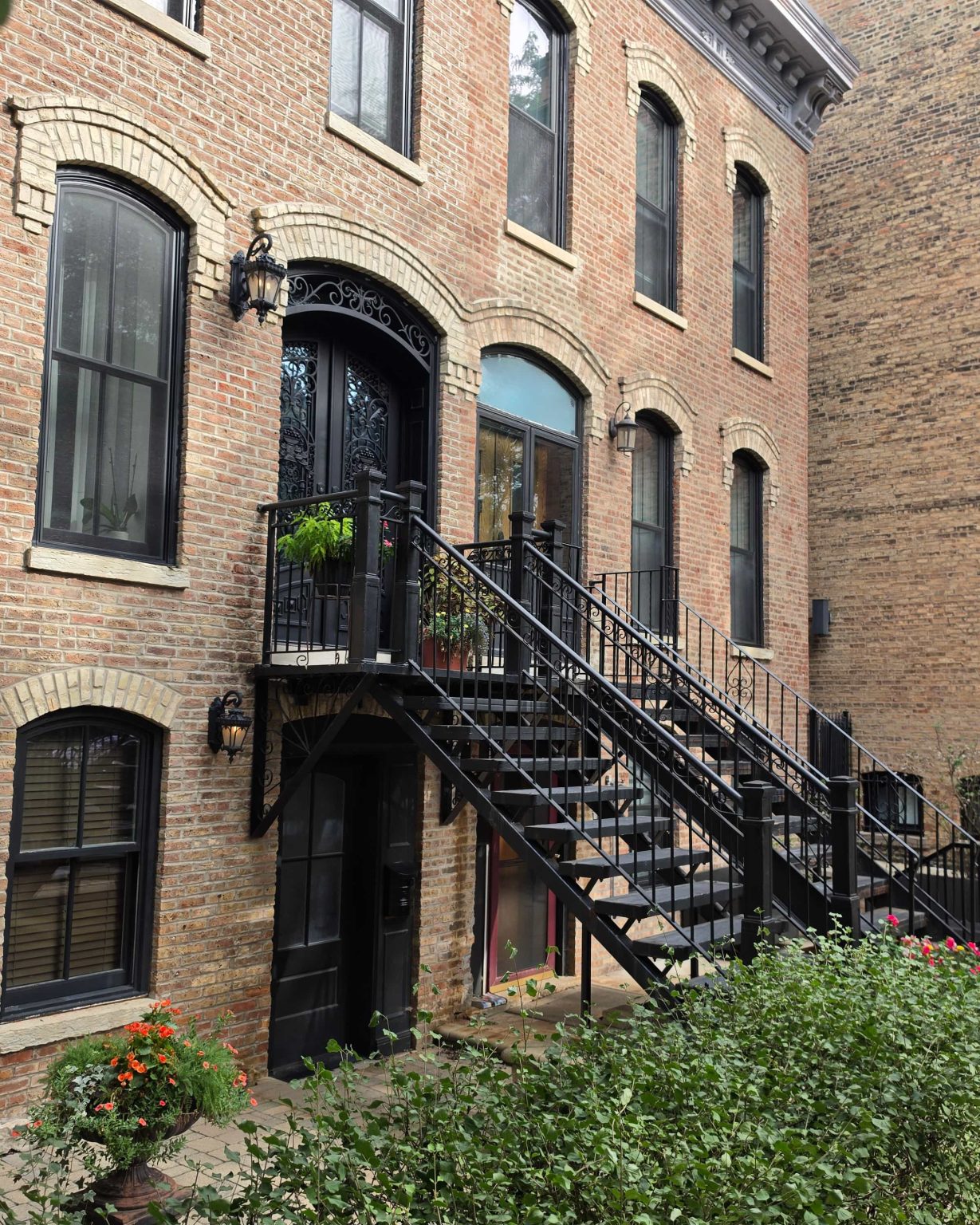 Brick homes with arched windows and iron entrance stairs in Old Town, Chicago