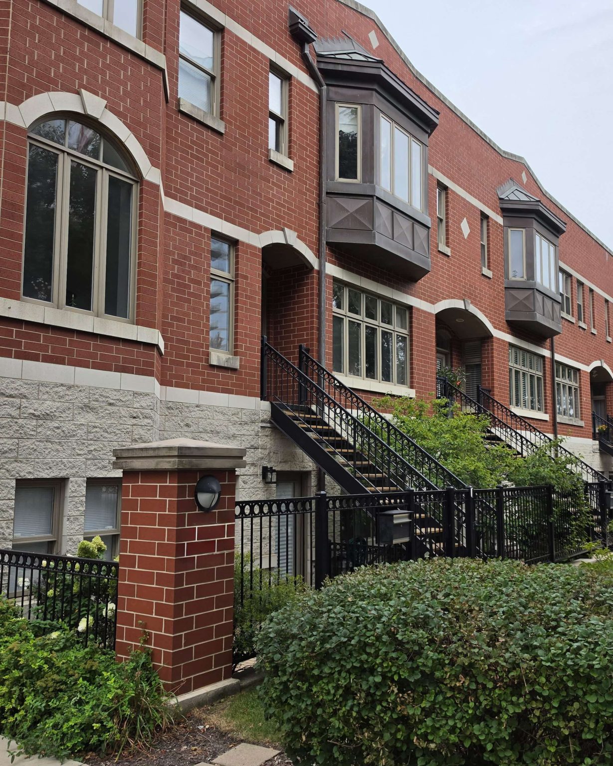 Red brick homes with bay windows and raised front entrances in South Loop, Chicago