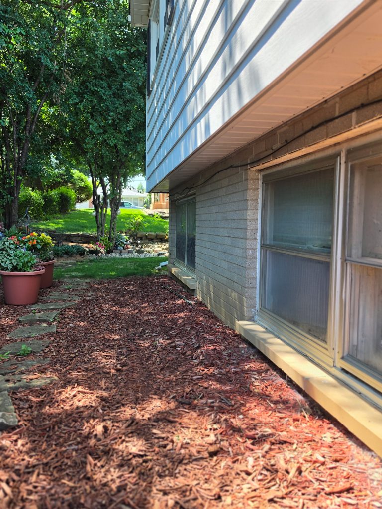 Residential exterior with lower wall, windows, mulch bed, and perimeter areas reviewed during general pest control service