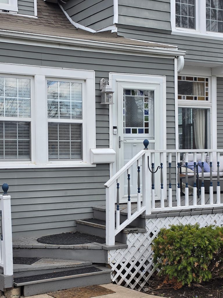 House exterior with porch, windows, railings, and exterior light reviewed during spider control service