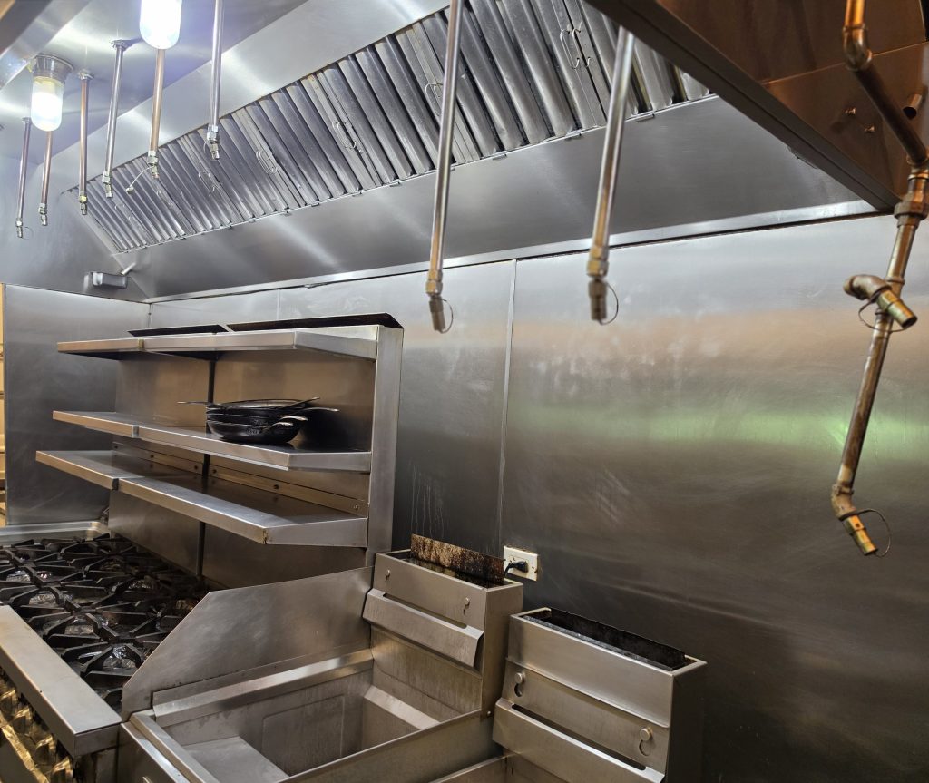 Commercial kitchen cook line with stainless equipment