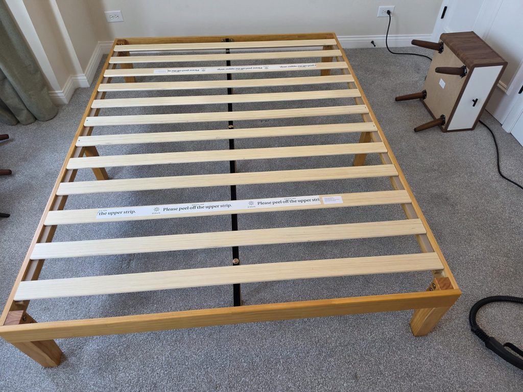 Disassembled wooden bed frame in a Lakeview bedroom before bed bug treatment