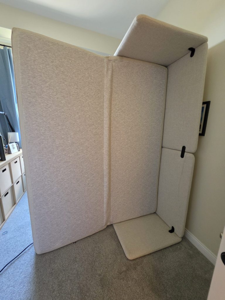 Upholstered mattress and bed base leaned upright during bed bug treatment preparation