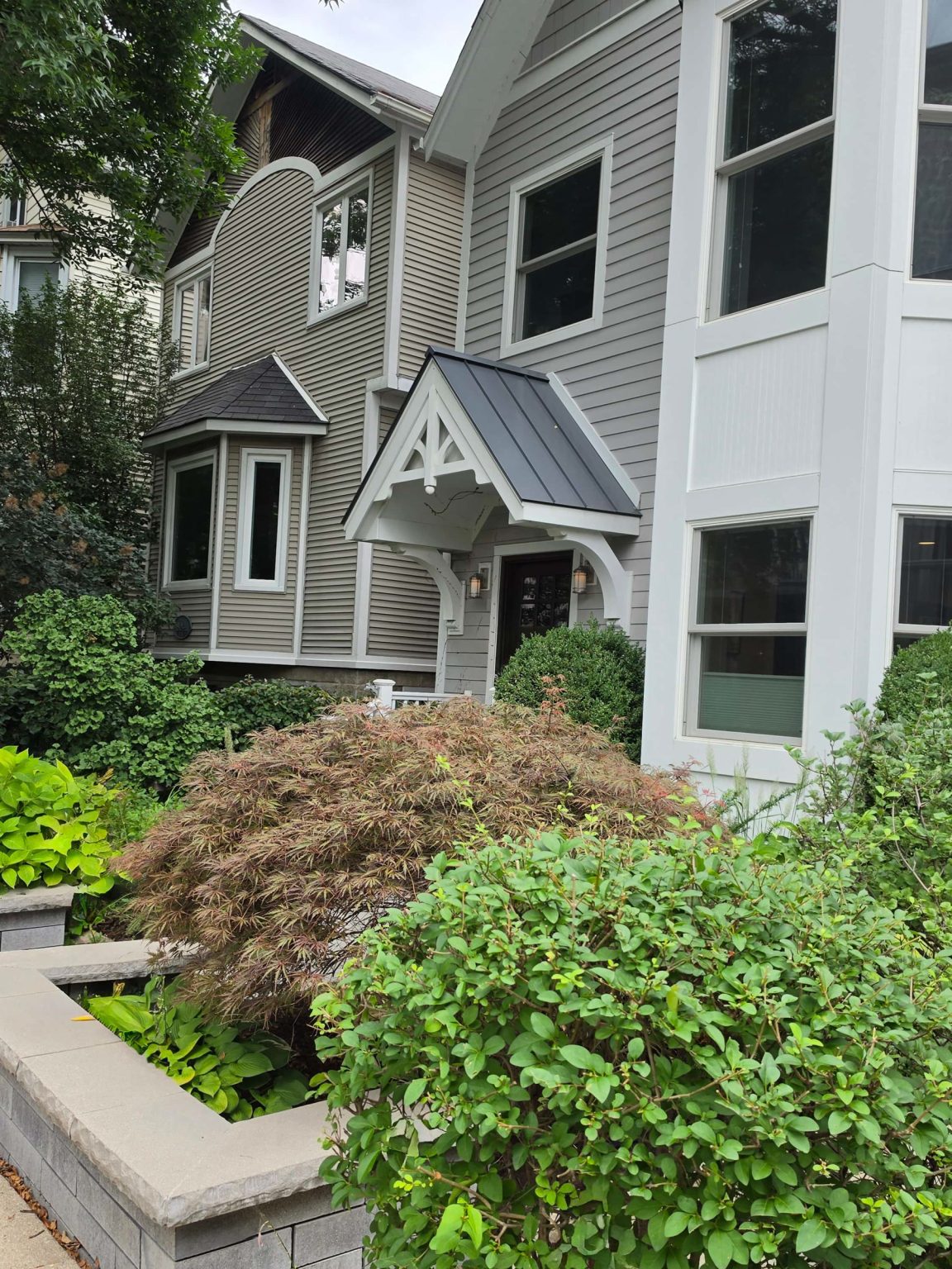 Closely spaced frame homes with bay windows and landscaped front gardens along a Lakeview sidewalk.