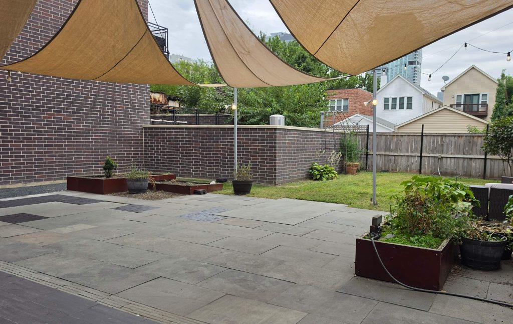 Backyard lawn, raised planting beds and paved patio in Old Town.