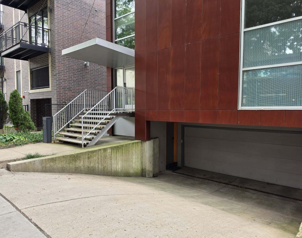 Residential facade with an entrance and garage in Old Town.