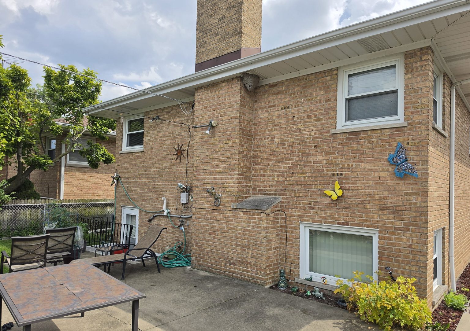 Skokie brick home with a wasp or hornet nest beneath the eave
